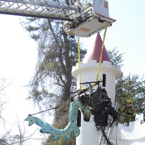 The Howard County Fire Department removes the remains of the Dragon from the Castle parapet